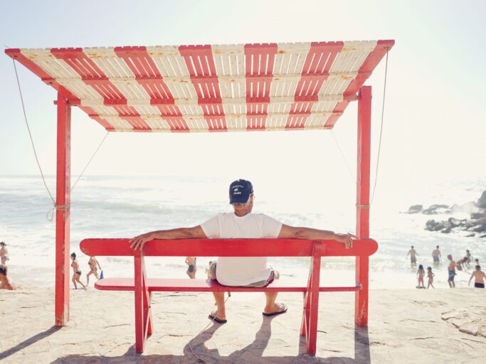 A retired man on a bench at the beach superannuation fund related