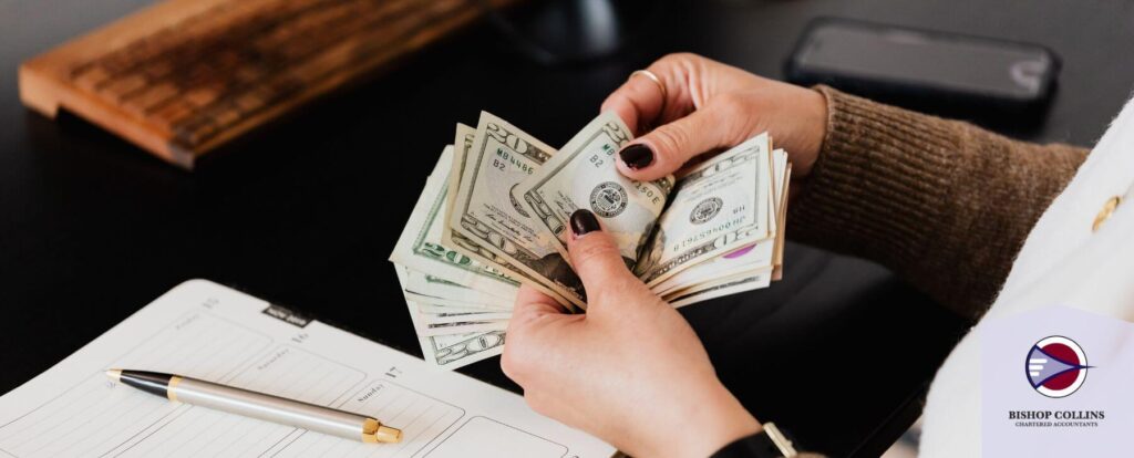 Business woman counting cash for tax planning purposes